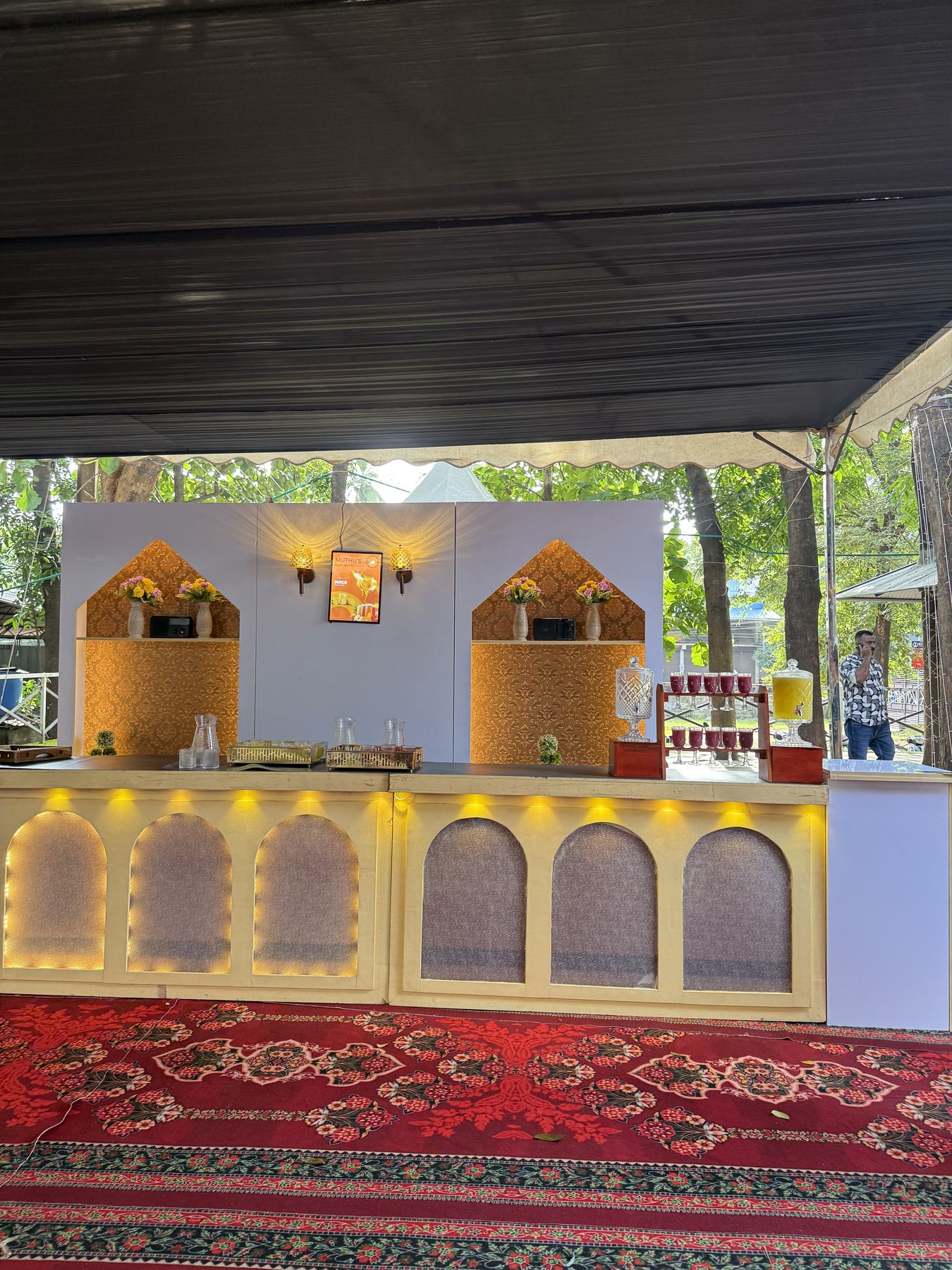 Outdoor catering and juice counter with lit arches