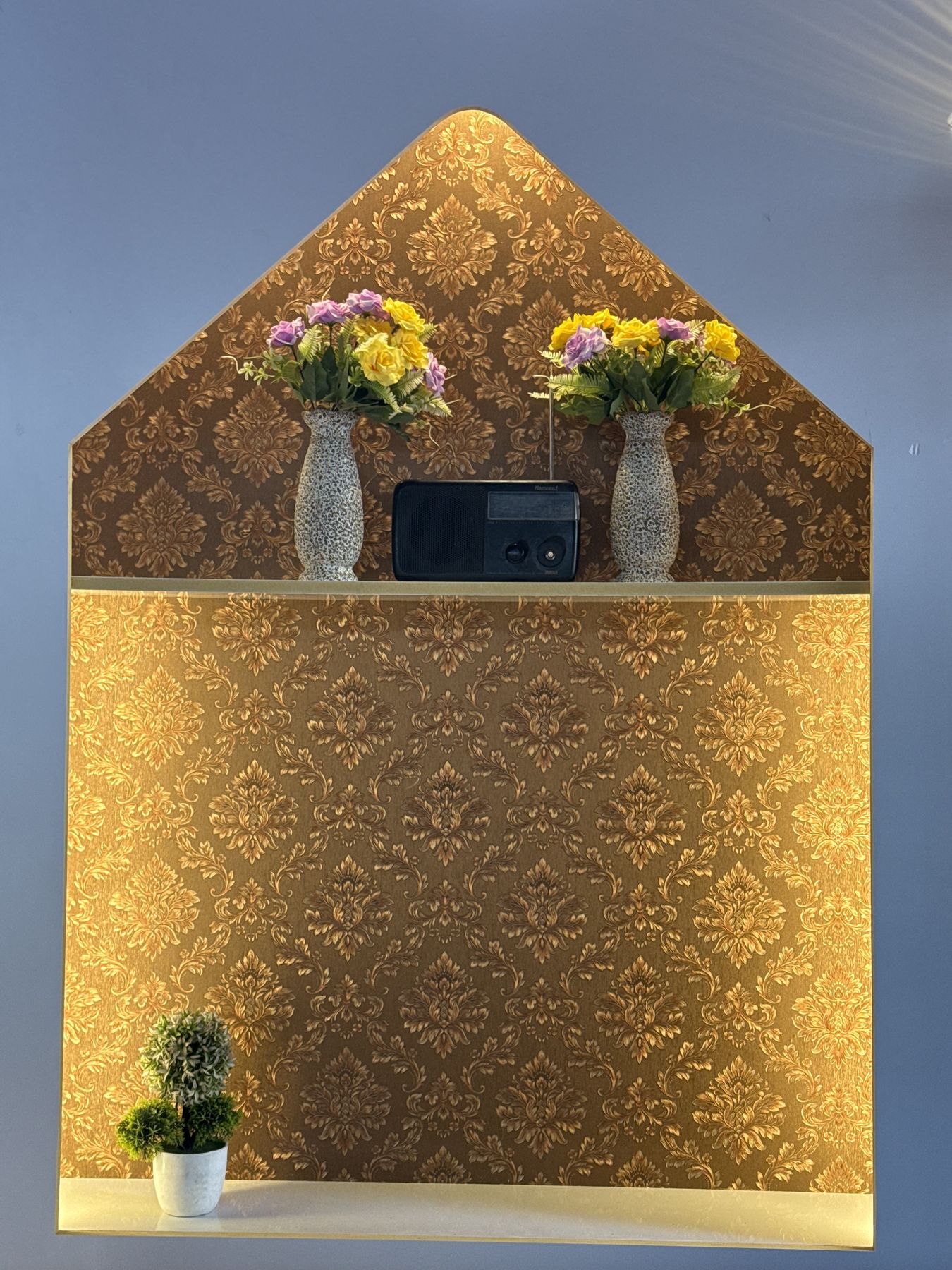 Gold damask décor niche with flower vases