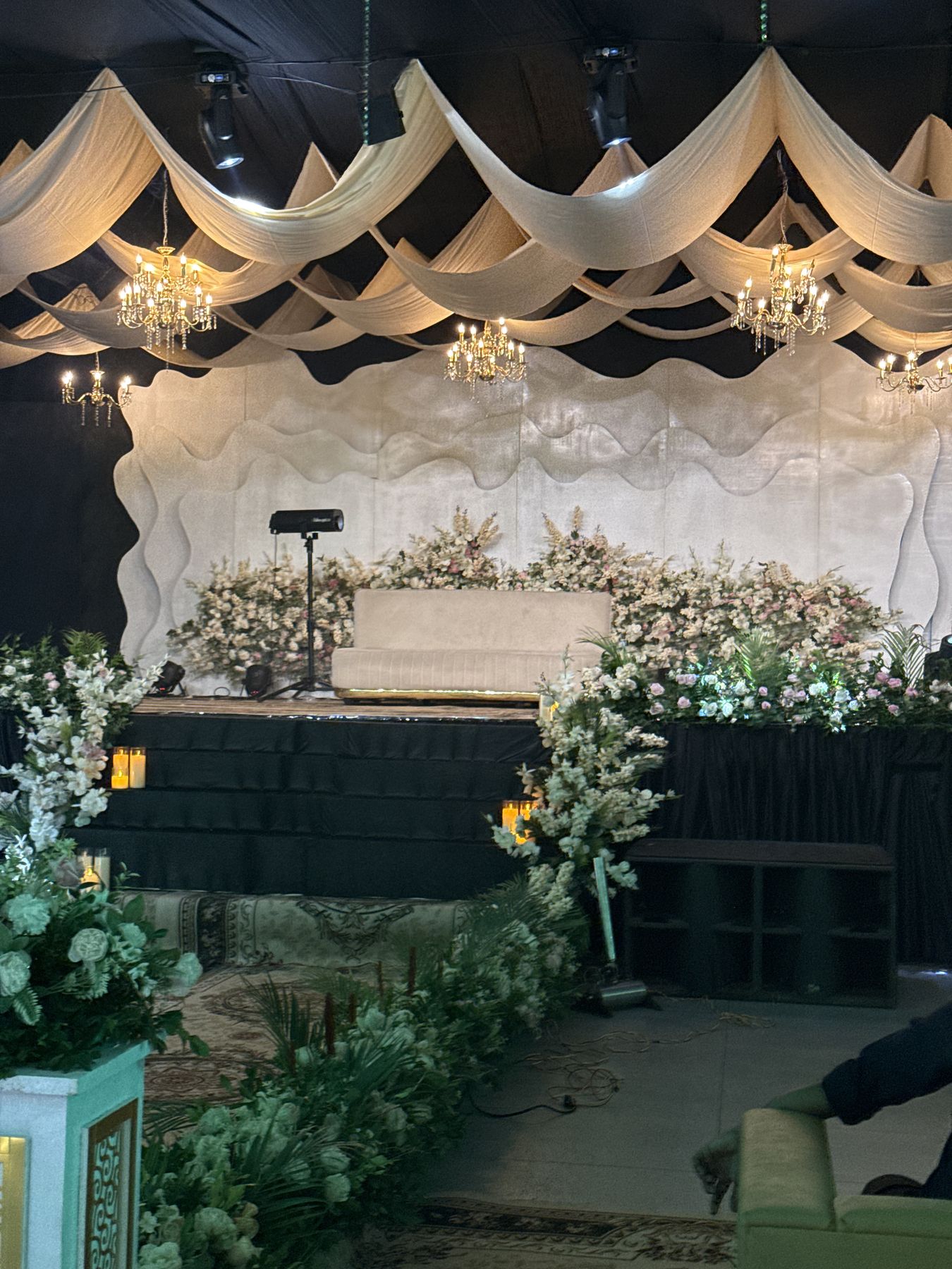 Wedding stage framed with white floral arrangements